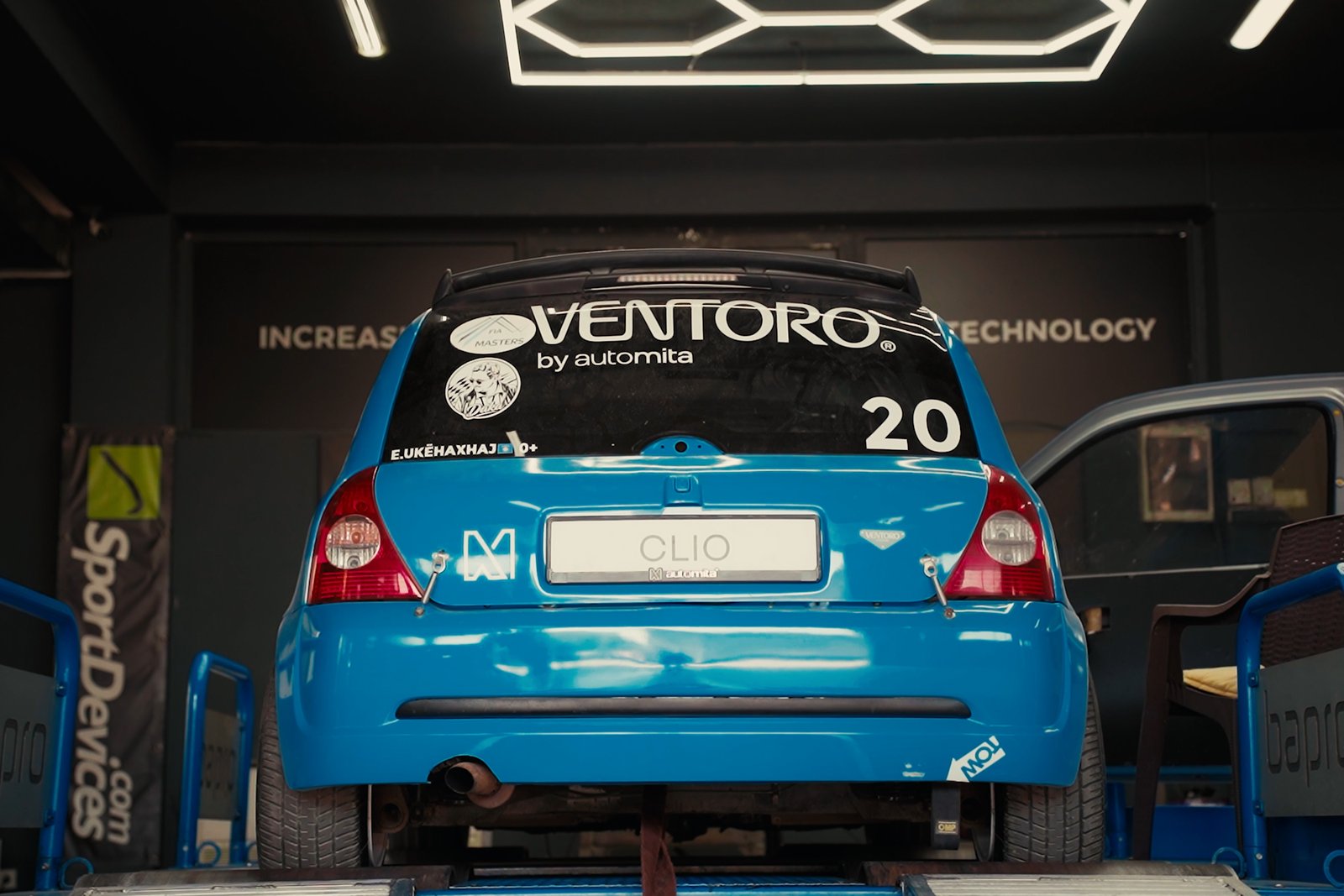 Blue performance car in the Roni Performance workshop, filmed and color graded by FlynLab.